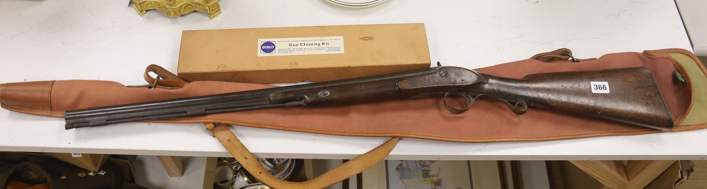 A 19th century percussion rifle, walnut stock, with ram rod, in canvas case, complete with gun cleaning kit